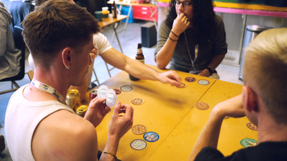 People playing Soggy Biscuit game at a table with cards.